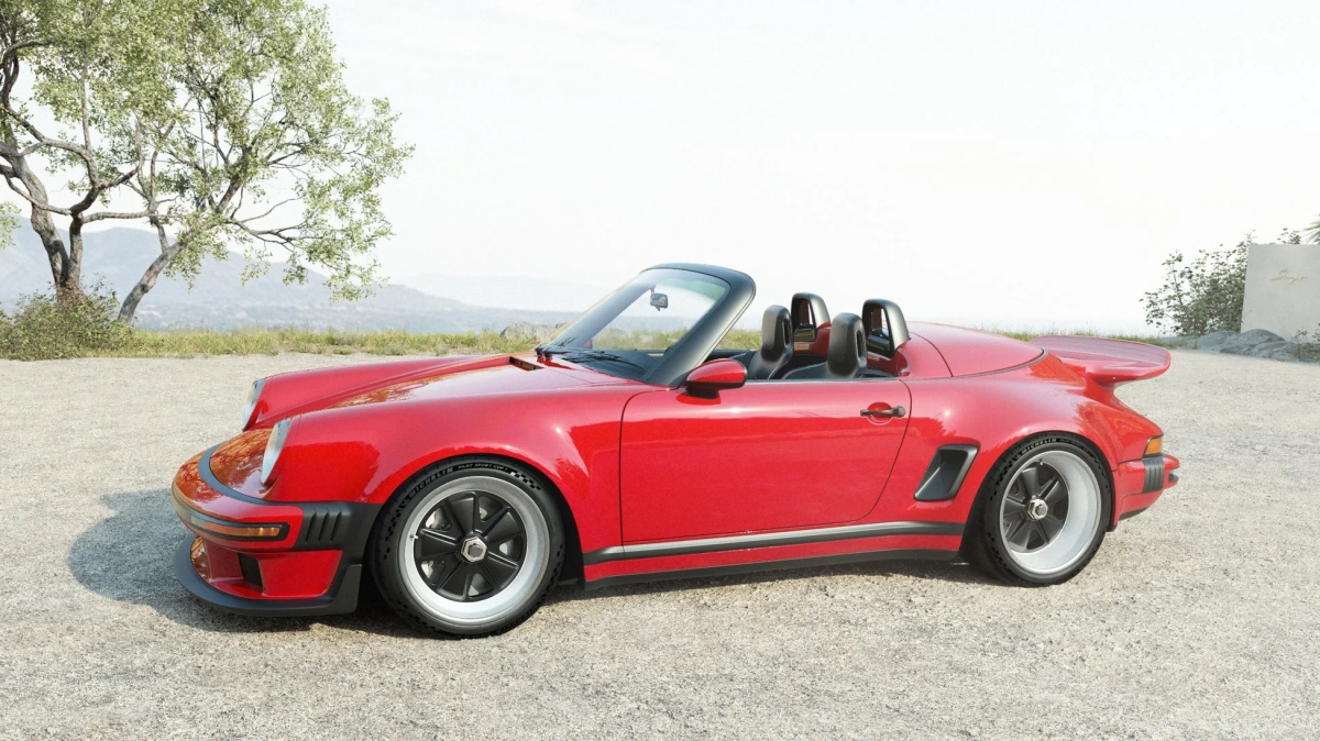 赤いポルシェ911スピードスターが砂利道に駐車されています