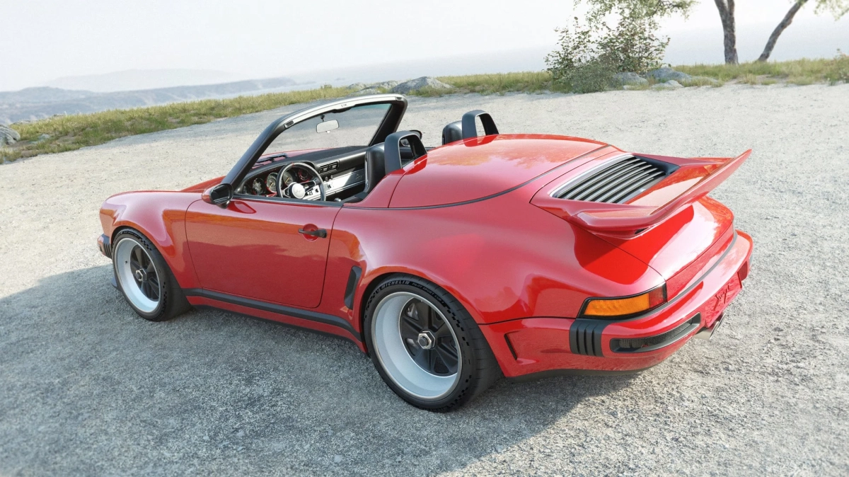 景色の良い山道に駐車された、鮮やかな赤いオープンカーのスポーツカー